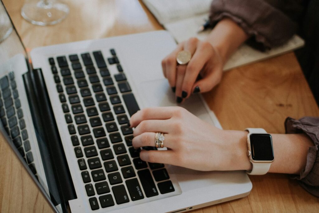 hands typing on laptop